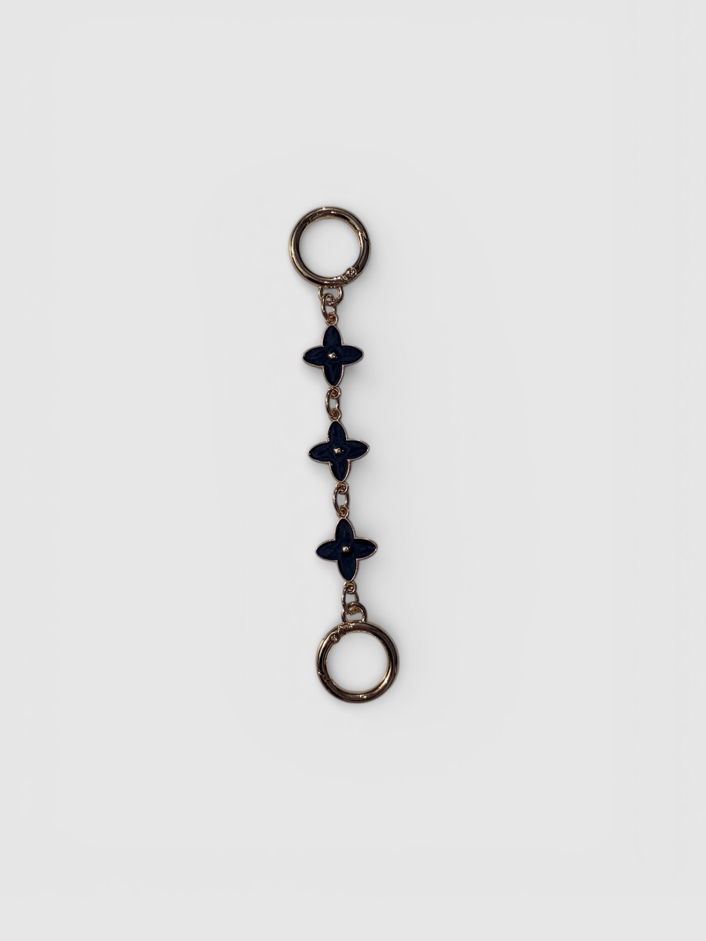 Flora chain strap extender by Rivolla — delicate triple floral link detail in porcelain, black and sienna