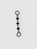 Flora chain strap extender by Rivolla — delicate triple floral link detail in porcelain, black and sienna