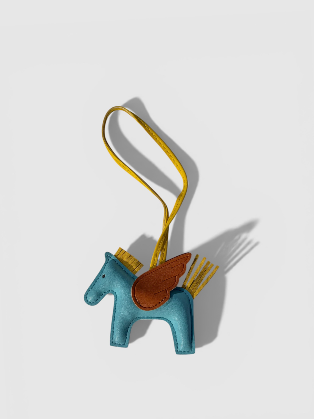 Pegasus leather bag charm by Rivolla — smooth leather horse with contrast wing and tassel mane detail