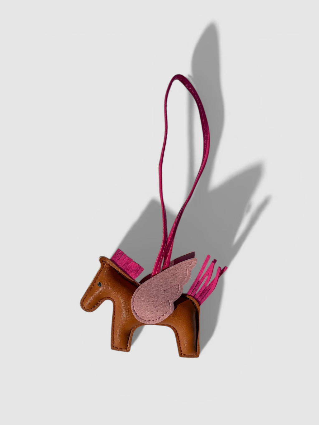 Pegasus leather bag charm by Rivolla — smooth leather horse with contrast wing and tassel mane detail
